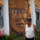 Harold Perry, 75, walks past a mural of Freddie Gray after Baltimore Police Officer Caesar Goodson Jr. was found not guilty of second-degree murder and all charges June 23, 2016, in the case of Freddie Gray, who died while in police custody. (Mark Makela/Getty Images)